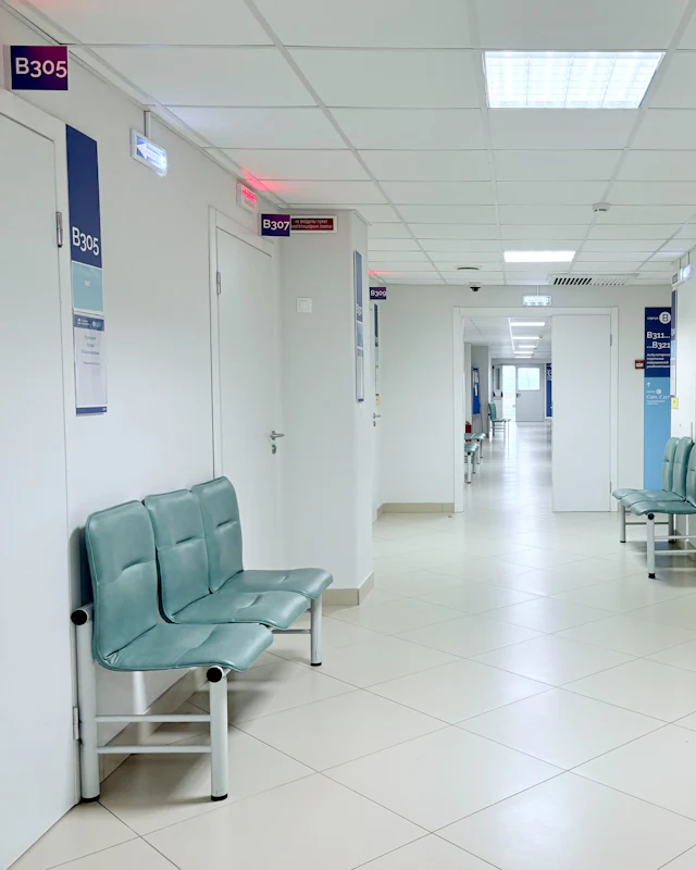 An empty hospital corridor with waiting chairs